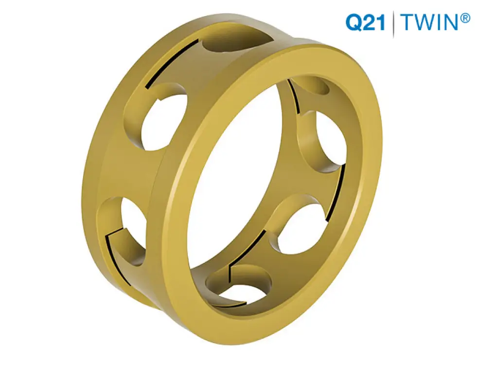 GRW Q21 TWIN® bearing cage in gold-coloured brass, showing the twin-row design with evenly spaced ball pockets, against a white background.