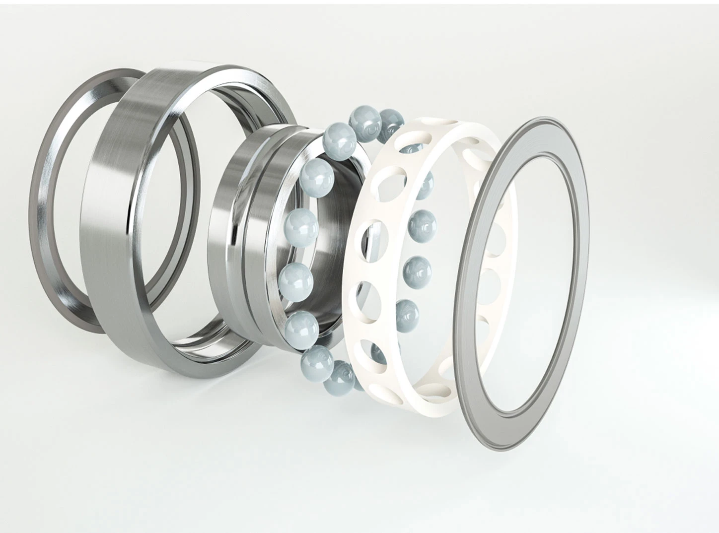 Exploded view of a ball bearing showing inner ring, outer ring, balls and polymer cage.
